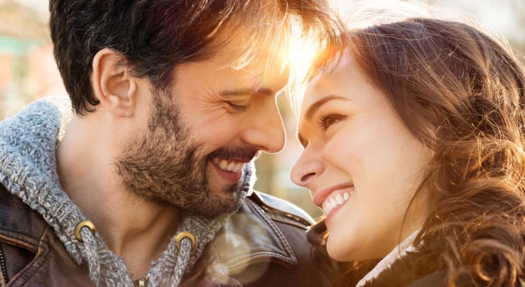 couple smiling after receiving dental crowns